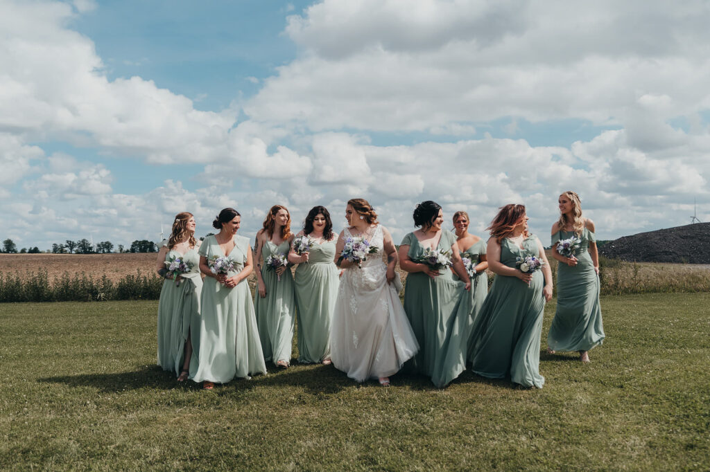 bride with her bridesmaids outside